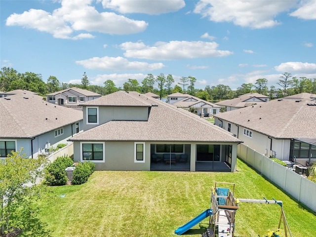 1741 Cherry Walk Rd, Lutz, FL 33558 - rear view of property featuring a yard, a shingled roof, a playground, and a residential view