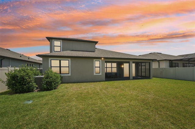 1741 Cherry Walk Rd, Lutz, FL 33558 - back of house at dusk with central air condition unit, a yard, stucco siding, and a fenced backyard