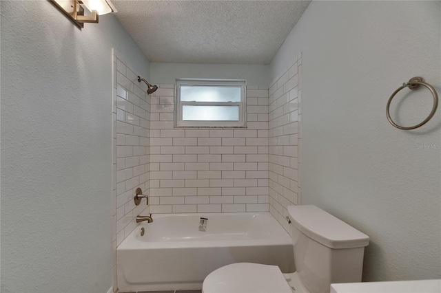 bathroom with a textured ceiling, a textured wall, and toilet
