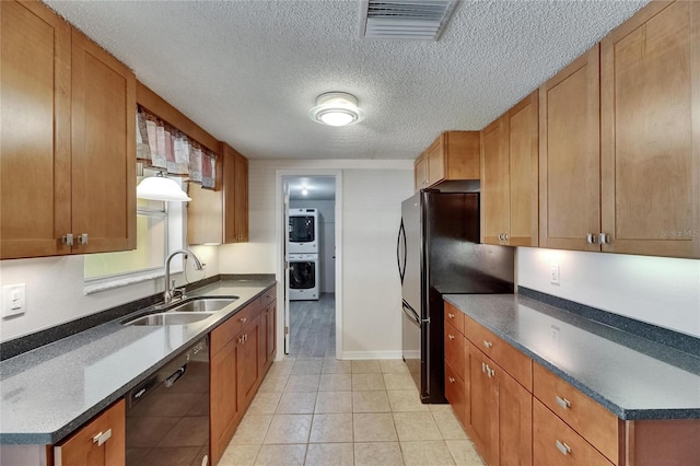 kitchen featuring a textured ceiling, visible vents, brown cabinets, a sink, and black appliances