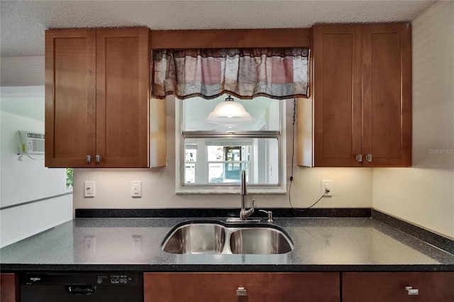 kitchen featuring brown cabinetry, a wall mounted air conditioner, a textured ceiling, a sink, and dishwasher