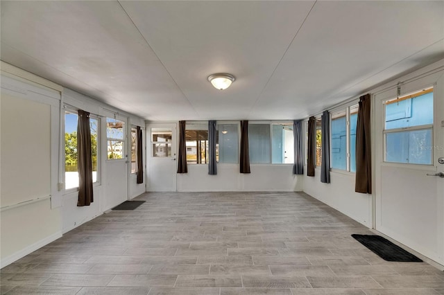 interior space with light wood-type flooring, a wealth of natural light, and visible vents