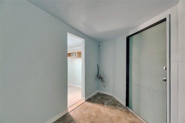 hall featuring baseboards