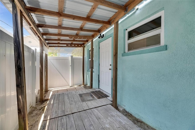 wooden terrace featuring fence