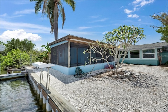 view of property exterior with a sunroom