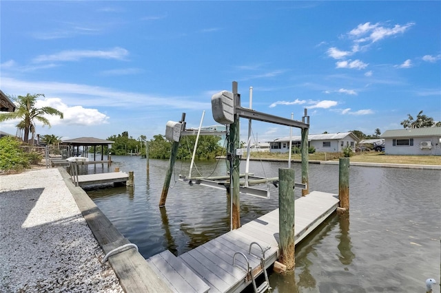 view of dock featuring boat lift and a water view