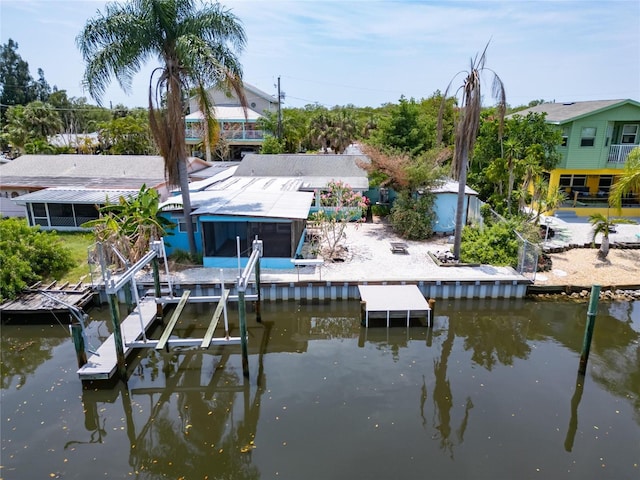 dock area with boat lift and a water view