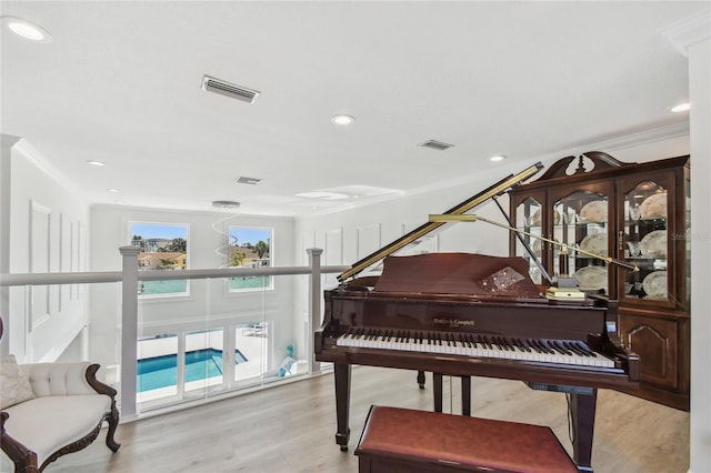 2233 Donato Dr, Belleair Beach, FL 33786 - living area featuring recessed lighting, ornamental molding, visible vents, and wood finished floors