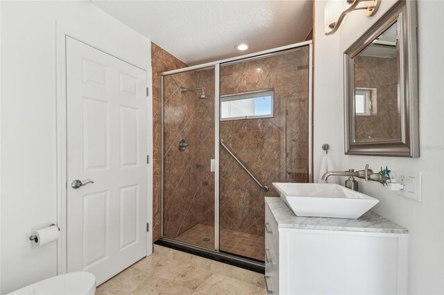2233 Donato Dr, Belleair Beach, FL 33786 - bathroom with vanity, toilet, a textured ceiling, and a shower stall