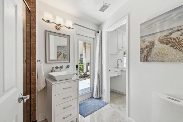 2233 Donato Dr, Belleair Beach, FL 33786 - bathroom with tile patterned flooring, vanity, and visible vents