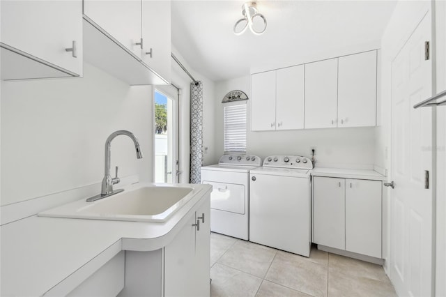 2233 Donato Dr, Belleair Beach, FL 33786 - washroom with washing machine and clothes dryer, a sink, light tile patterned floors, and cabinet space