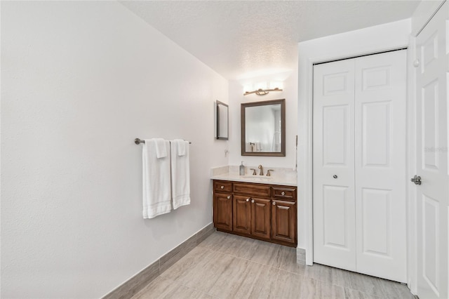 2233 Donato Dr, Belleair Beach, FL 33786 - bathroom featuring baseboards, a closet, and vanity