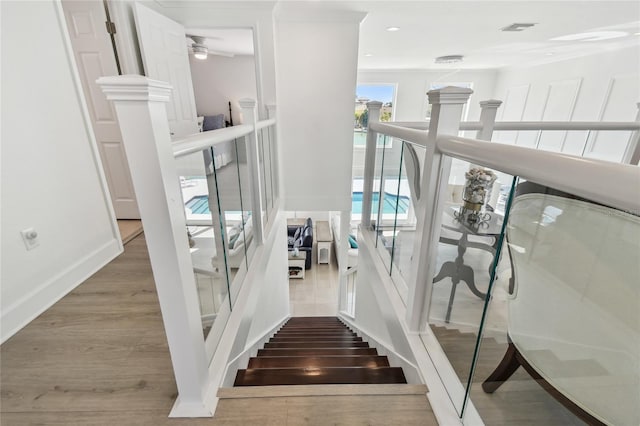 2233 Donato Dr, Belleair Beach, FL 33786 - stairs with baseboards, visible vents, wood finished floors, and a ceiling fan