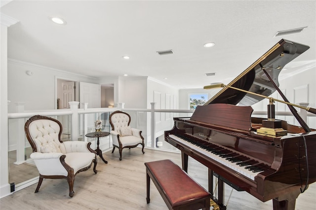 2233 Donato Dr, Belleair Beach, FL 33786 - living area featuring recessed lighting, visible vents, crown molding, and wood finished floors