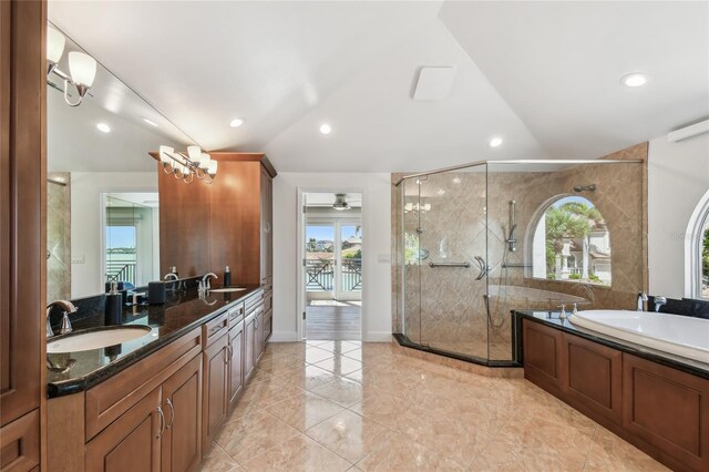 2233 Donato Dr, Belleair Beach, FL 33786 - bathroom featuring a stall shower, a garden tub, a sink, and vaulted ceiling