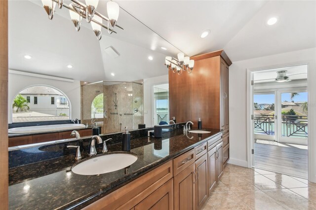 2233 Donato Dr, Belleair Beach, FL 33786 - full bathroom with tile patterned floors, vaulted ceiling, a stall shower, and a sink