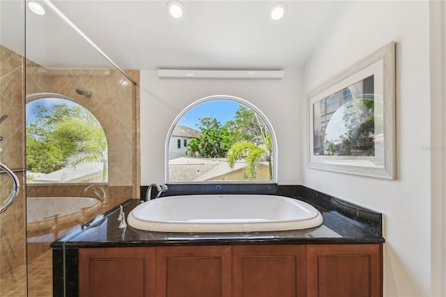 2233 Donato Dr, Belleair Beach, FL 33786 - full bath with recessed lighting, a garden tub, and a tile shower