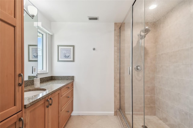 2233 Donato Dr, Belleair Beach, FL 33786 - bathroom with vanity, visible vents, tile patterned floors, a shower stall, and baseboards