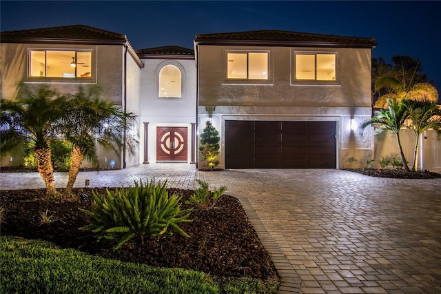 2233 Donato Dr, Belleair Beach, FL 33786 - mediterranean / spanish home featuring stucco siding, decorative driveway, and a garage