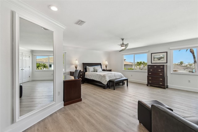 2233 Donato Dr, Belleair Beach, FL 33786 - bedroom with multiple windows, wood finished floors, visible vents, and baseboards
