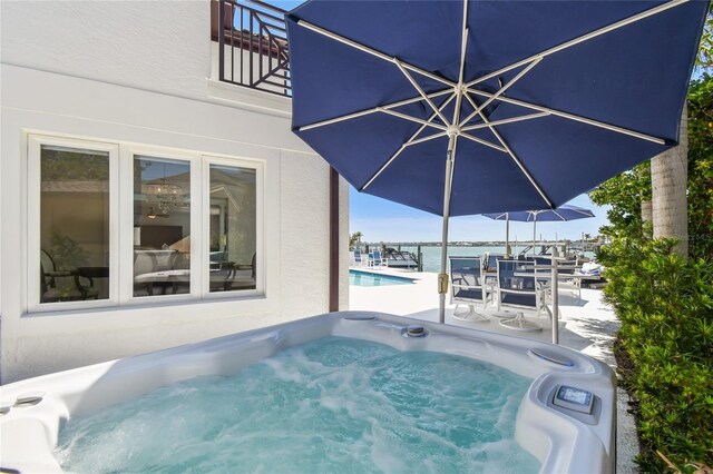2233 Donato Dr, Belleair Beach, FL 33786 - pool featuring a hot tub, a patio area, and a water view