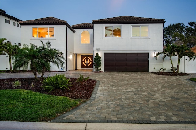 2233 Donato Dr, Belleair Beach, FL 33786 - mediterranean / spanish home with stucco siding, a tile roof, a garage, and decorative driveway