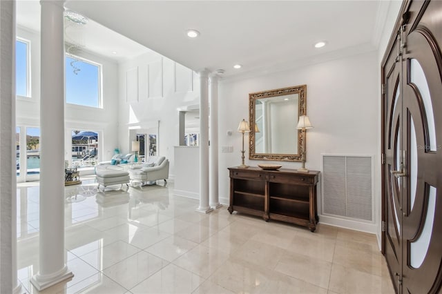 2233 Donato Dr, Belleair Beach, FL 33786 - foyer with light tile patterned floors, decorative columns, crown molding, visible vents, and baseboards