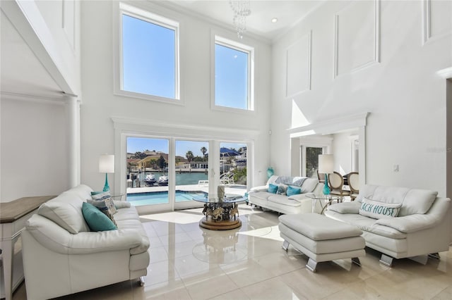2233 Donato Dr, Belleair Beach, FL 33786 - living room featuring tile patterned floors, a high ceiling, and crown molding