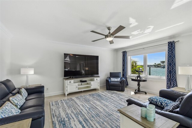 2233 Donato Dr, Belleair Beach, FL 33786 - living area with crown molding, baseboards, and a ceiling fan