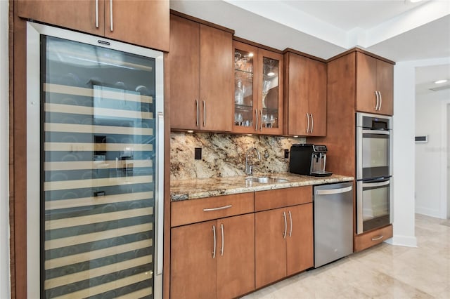 2233 Donato Dr, Belleair Beach, FL 33786 - kitchen featuring a sink, stainless steel appliances, tasteful backsplash, beverage cooler, and light stone countertops