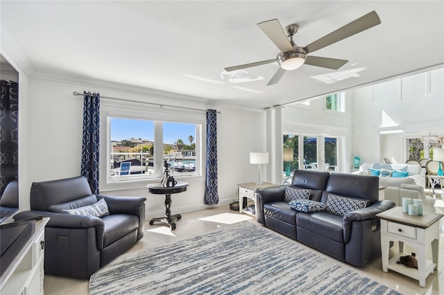 2233 Donato Dr, Belleair Beach, FL 33786 - living room with ceiling fan, crown molding, ornate columns, and a healthy amount of sunlight