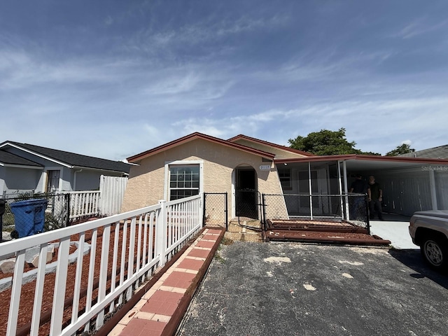 manufactured / mobile home featuring an attached carport and stucco siding