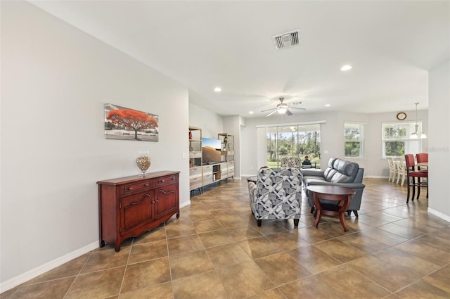 tiled living area with recessed lighting, a ceiling fan, visible vents, and baseboards