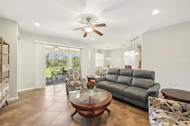 tiled living room with recessed lighting, a ceiling fan, and baseboards