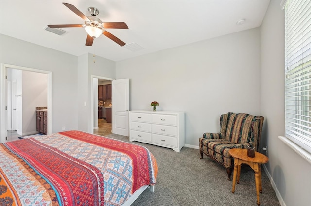bedroom featuring baseboards, visible vents, a ceiling fan, and light carpet