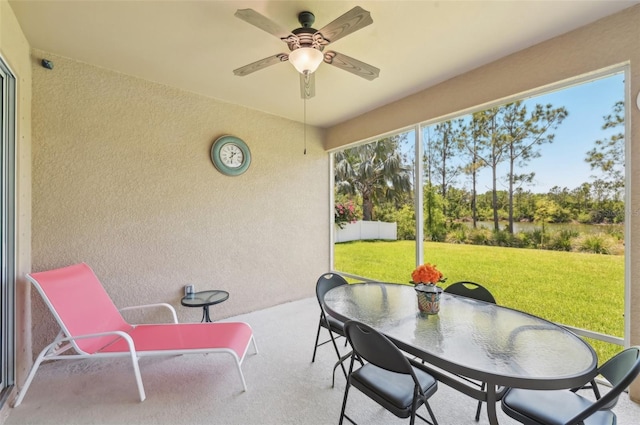sunroom featuring ceiling fan