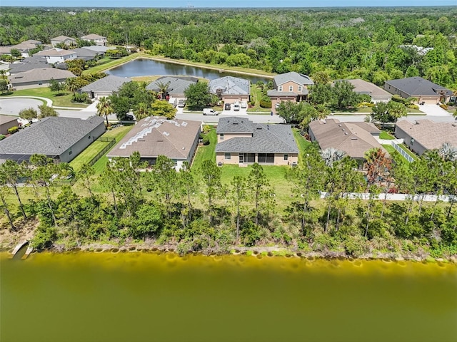 bird's eye view with a wooded view, a water view, and a residential view