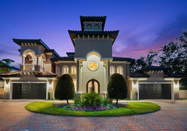 1600 Magnolia Rd, Belleair, FL 33756 - mediterranean / spanish-style house with a balcony, decorative driveway, stucco siding, and a tiled roof