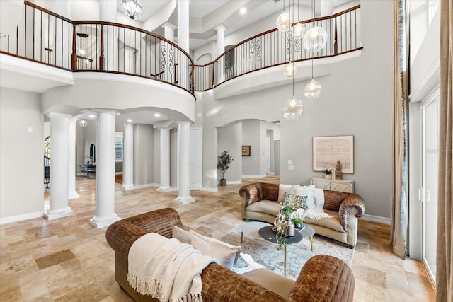 1600 Magnolia Rd, Belleair, FL 33756 - living area featuring ornate columns, a high ceiling, and baseboards