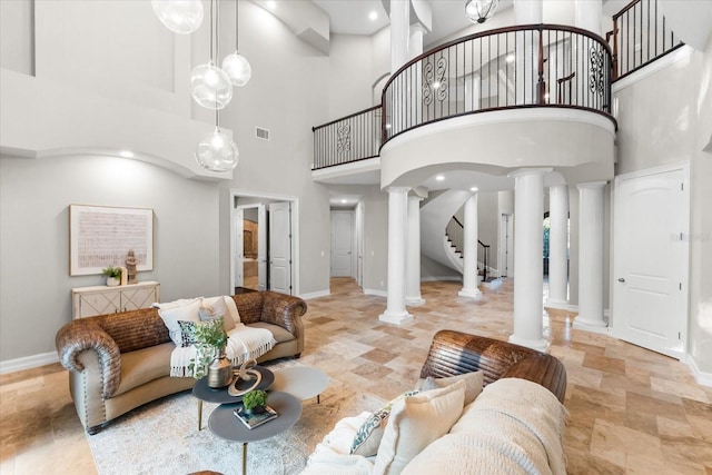1600 Magnolia Rd, Belleair, FL 33756 - living area featuring decorative columns, a high ceiling, baseboards, and stairs