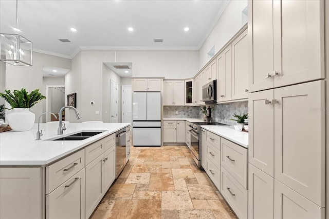 1600 Magnolia Rd, Belleair, FL 33756 - kitchen with stainless steel appliances, a sink, crown molding, decorative backsplash, and stone tile flooring