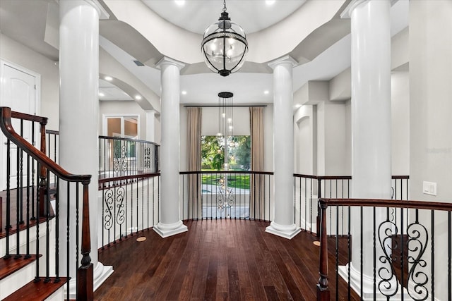 1600 Magnolia Rd, Belleair, FL 33756 - hallway with ornate columns, wood-type flooring, and baseboards