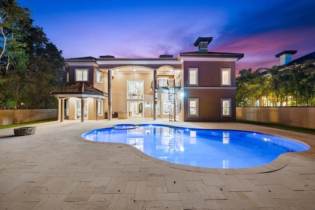 1600 Magnolia Rd, Belleair, FL 33756 - pool at dusk with a patio area, french doors, and stairway