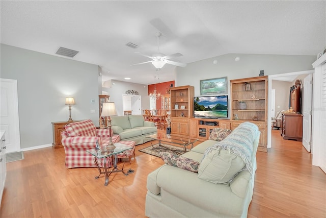 living area featuring lofted ceiling, visible vents, ceiling fan with notable chandelier, and light wood-style floors