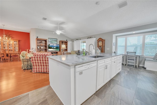 kitchen with visible vents, dishwasher, white cabinetry, and a sink