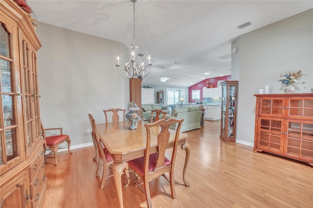dining space featuring visible vents, baseboards, light wood finished floors, and ceiling fan with notable chandelier