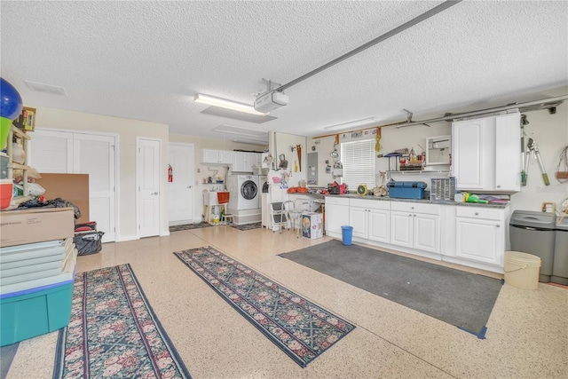 garage with a garage door opener and electric panel