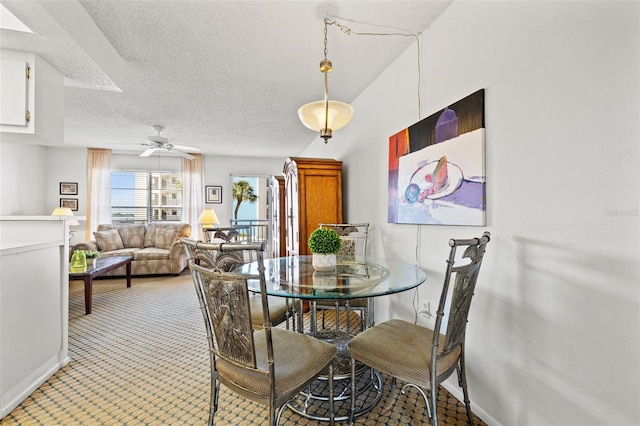 dining area with baseboards, a textured ceiling, and ceiling fan