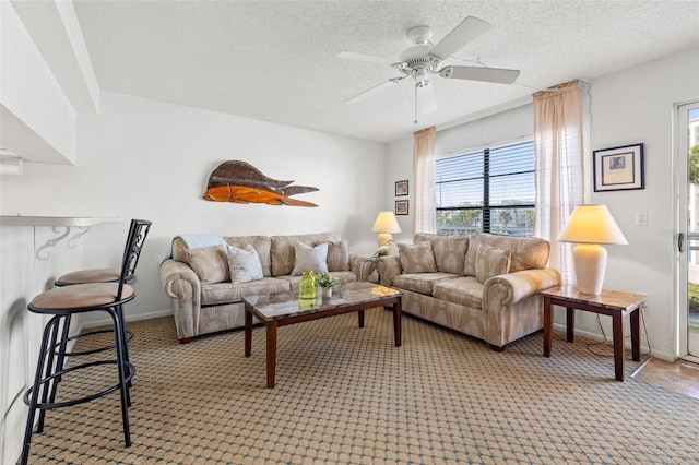 9755 Harrell Ave Unit 101, Treasure Island, FL 33706 - carpeted living area featuring ceiling fan and a textured ceiling