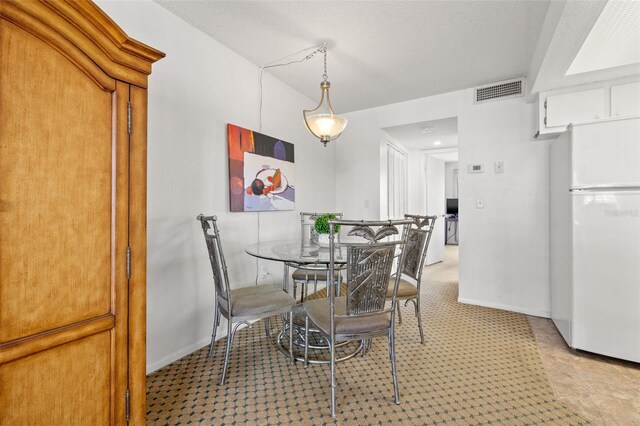 9755 Harrell Ave Unit 101, Treasure Island, FL 33706 - dining space with baseboards and carpet